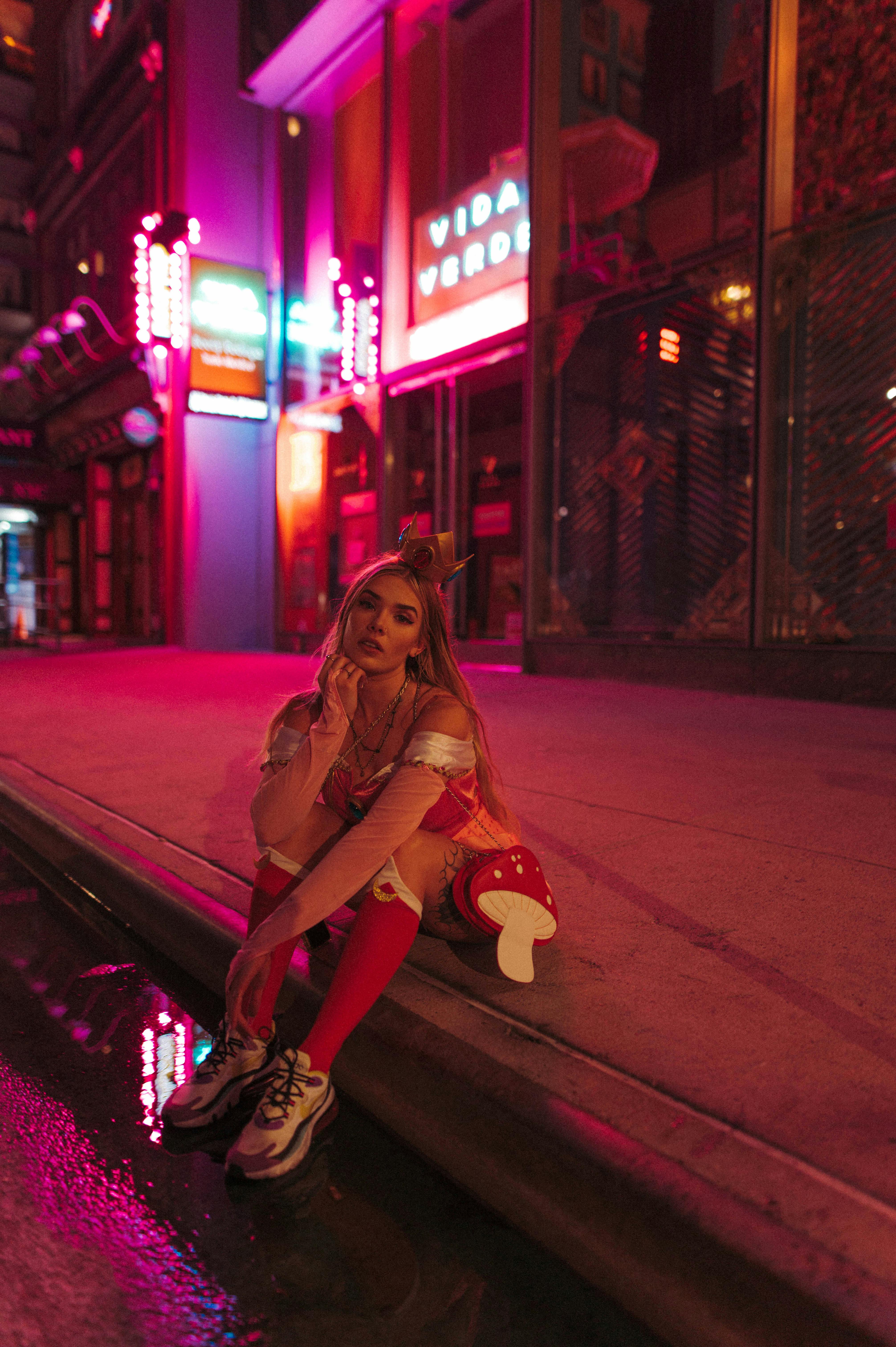 a cosplayer sitting on a curb