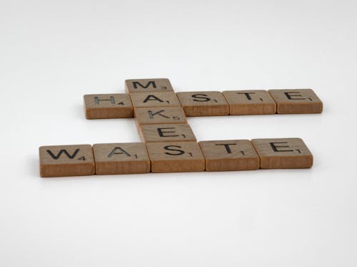 Brown Wooden Scrabble Tiles on White Surface