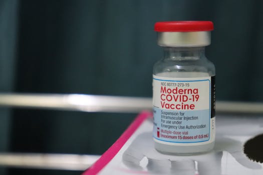 A close-up view of a Moderna COVID-19 vaccine vial, emphasizing healthcare and immunization.