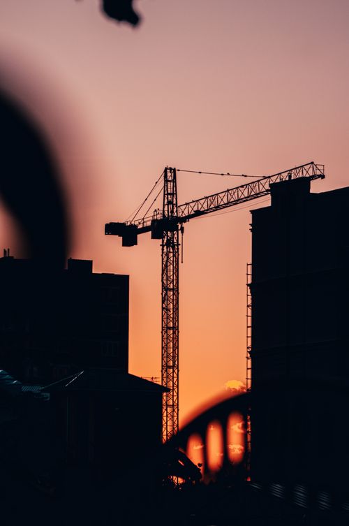 Free Dramatic sunset silhouette of a tower crane in Kaliningrad, Russia, depicting urban construction. Stock Photo