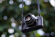 Black Dslr Camera on Black Tripod