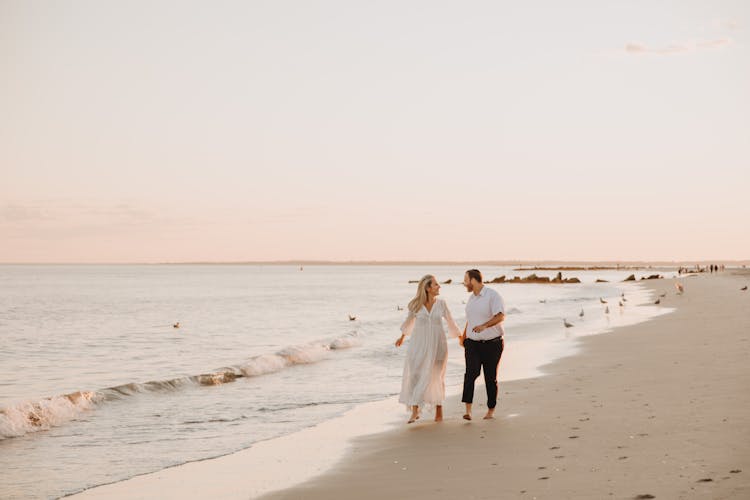 Couple Walking Together On Beach