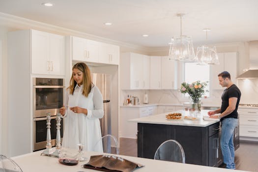A man and woman preparing a meal together in a bright, modern kitchen.