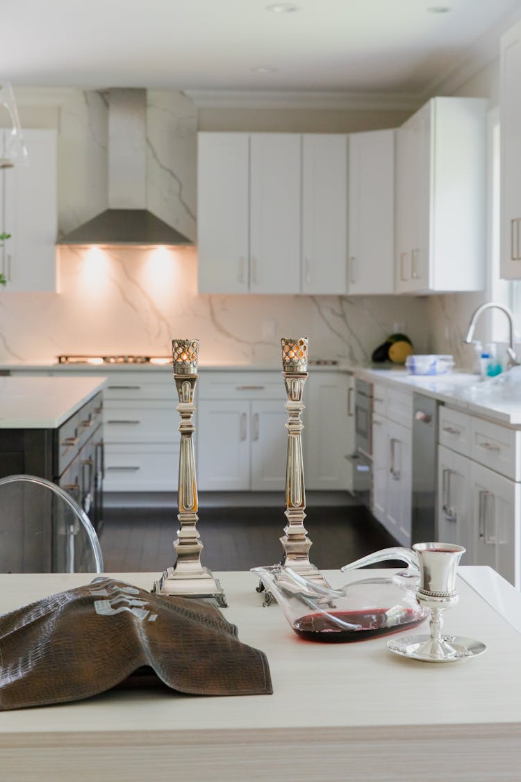 Candle Holders, Wine And A Cup On A Kitchen Counter 