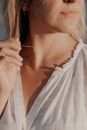 A Woman Holding her Necklace
