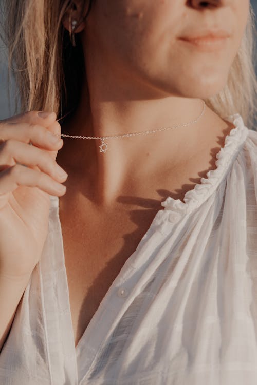 Free A Woman Holding her Necklace Stock Photo