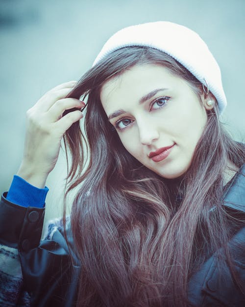 Woman in Blue Jacket Holding Her Hair