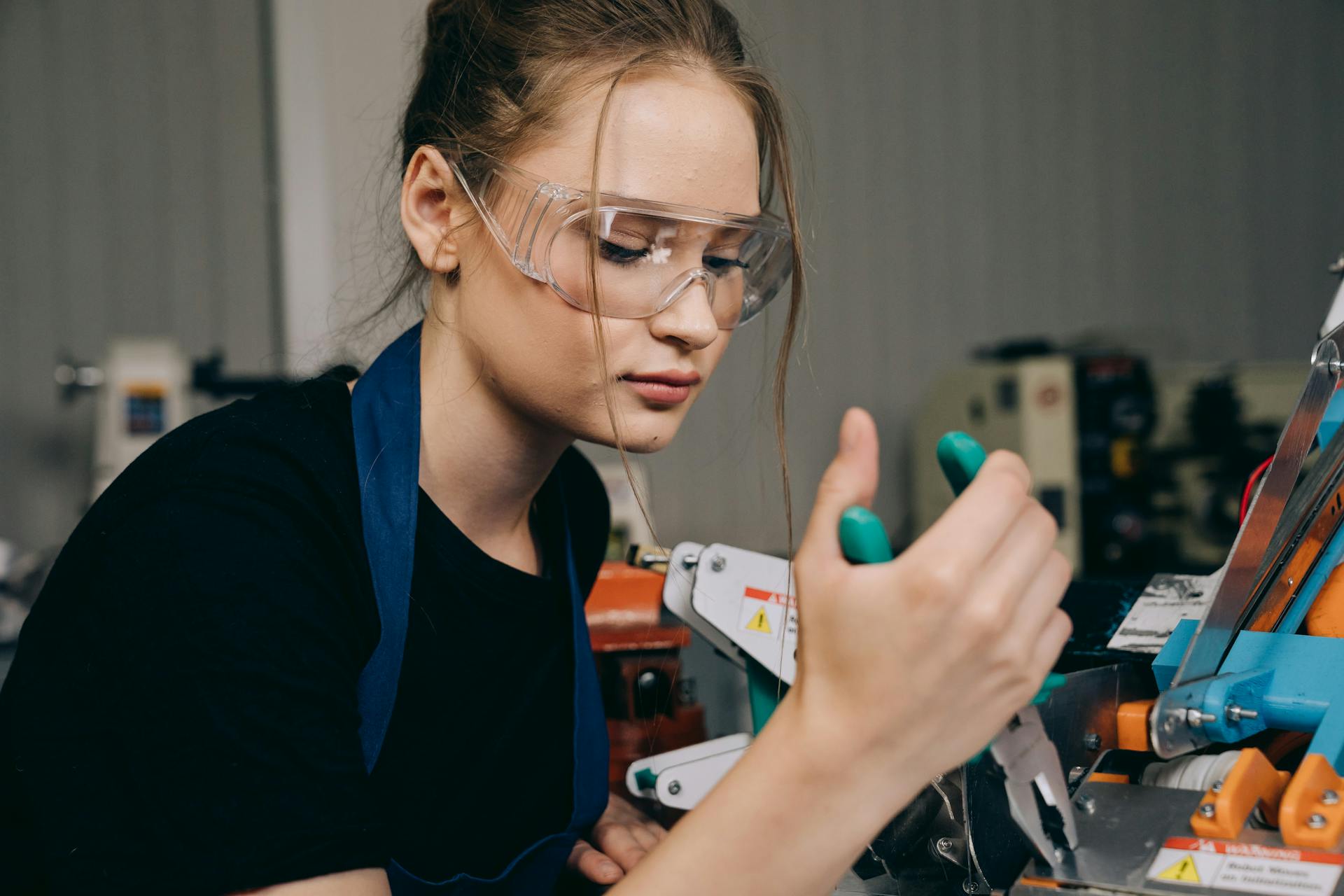 A Woman Using a Pliers at Work