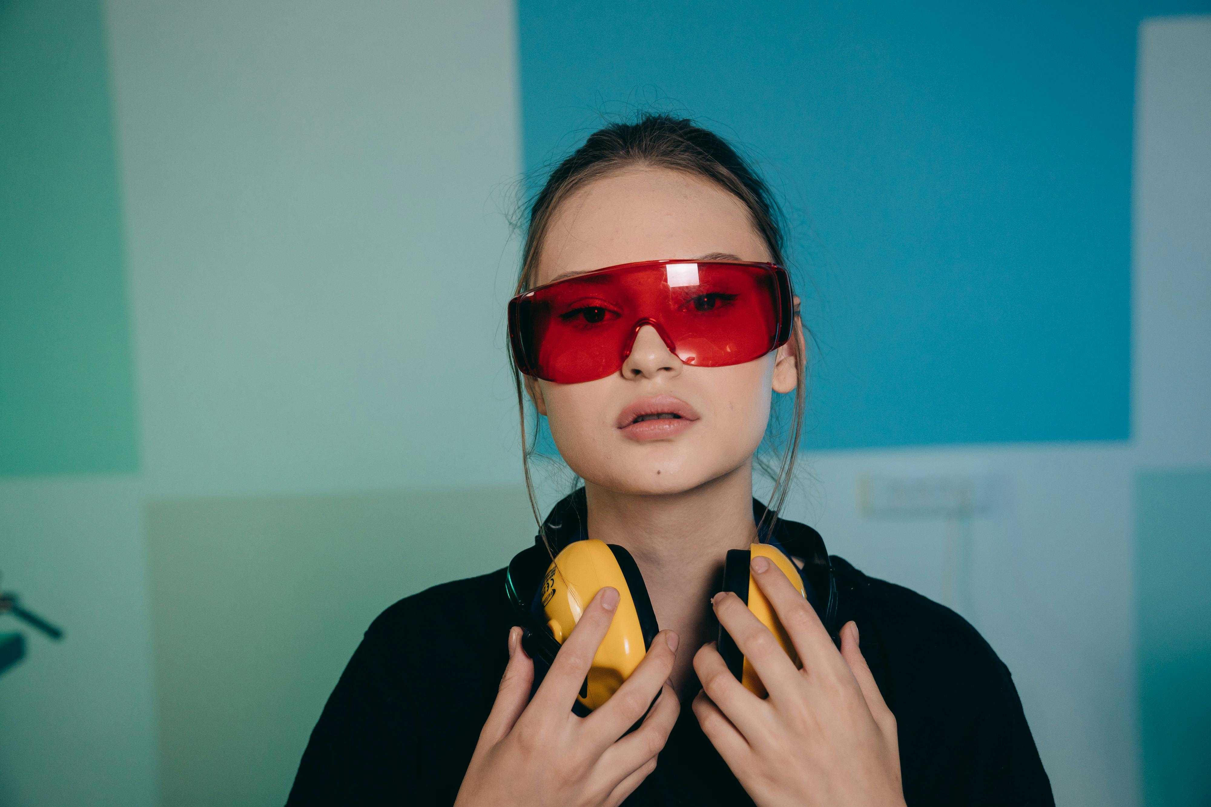 a portrait of a young woman wearing safety glasses
