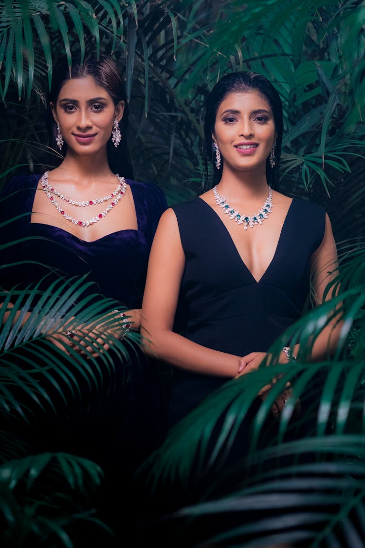 Portrait Of Two Women Wearing Black Dresses