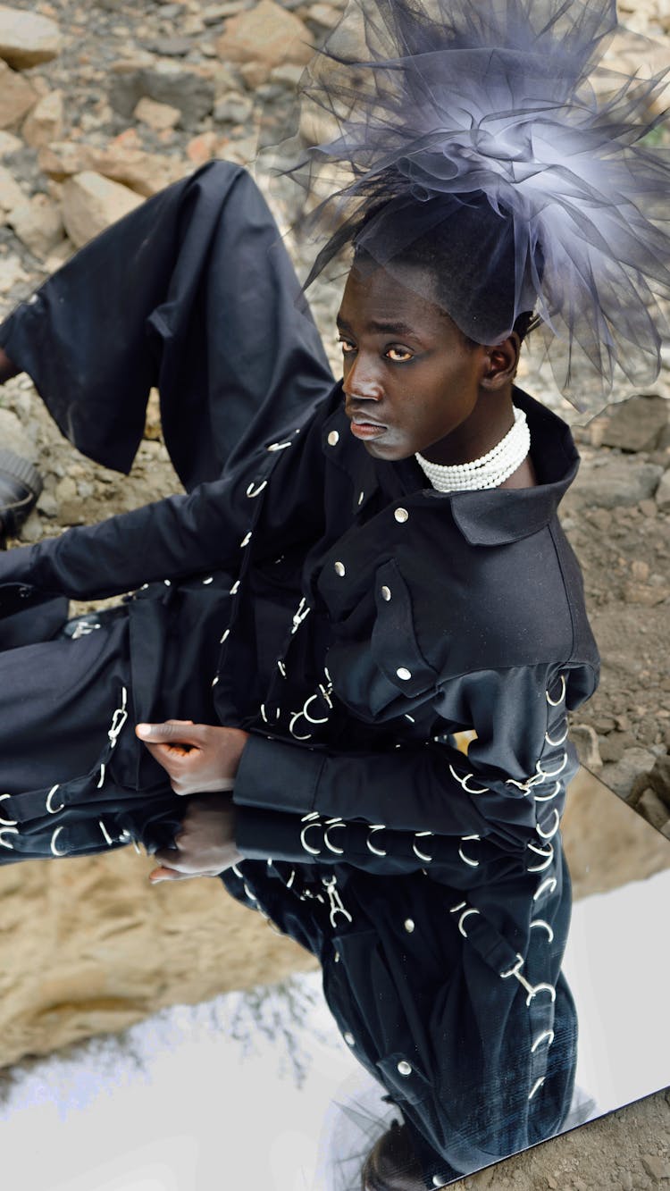 Man In A Black Outfit And Tulle Headdress 