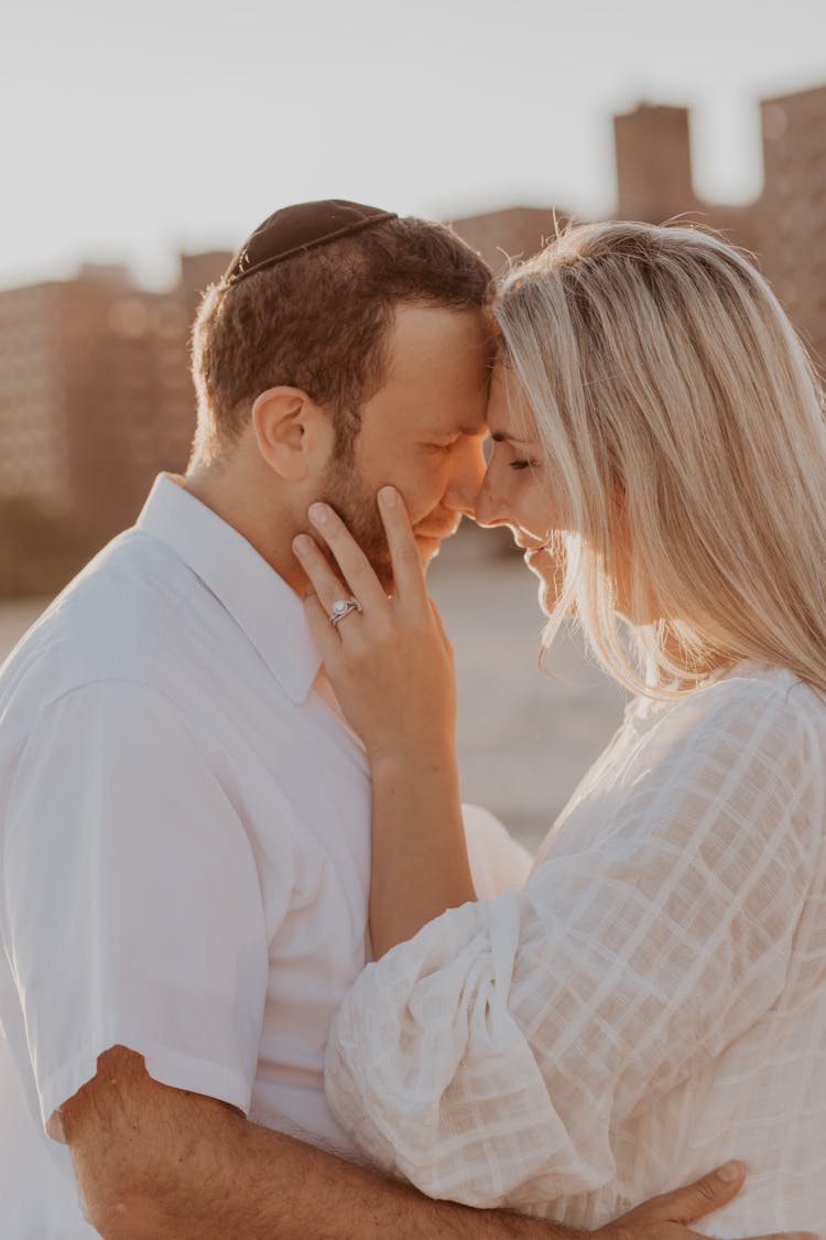 Couple Standing Face To Face And Embracing