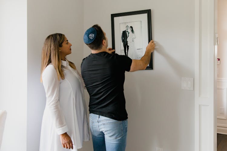 Jewish Couple Hanging Framed Photo On Wall