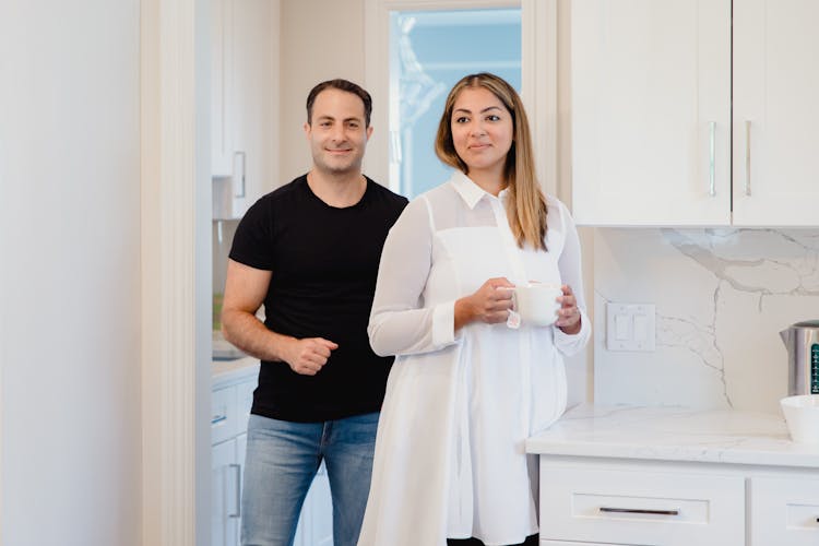 A Couple Standing In A Kitchen