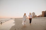Man and Woman Holding Hands on Beach