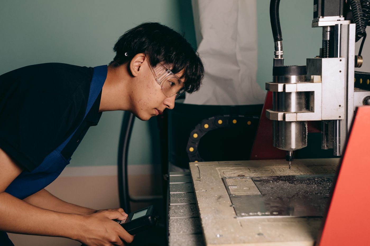 engineer operating a CNC machine control panel