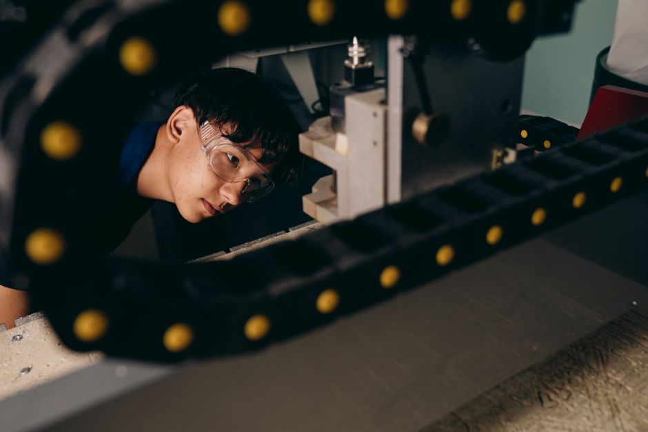 factory worker inspecting machinery