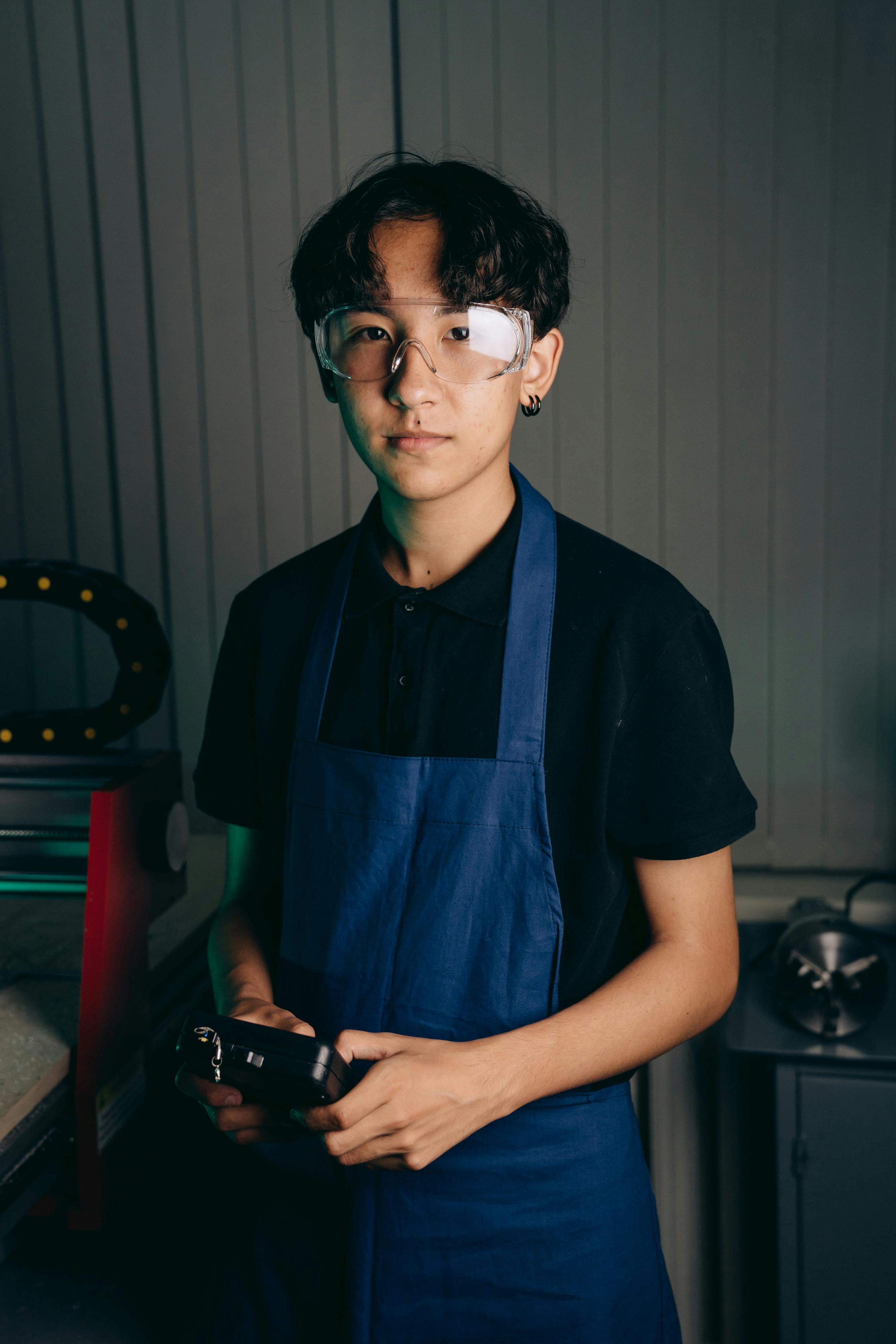 a man wearing safety glasses and apron