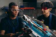 Two Boys Wearing Safety Glasses Near a Metal Frame