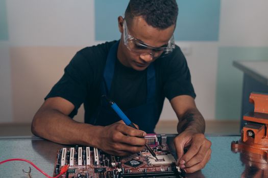 Close-up of a Man Fixing Electronic