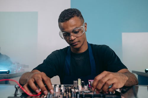 An Electrical Engineer Working on a Circuit Board