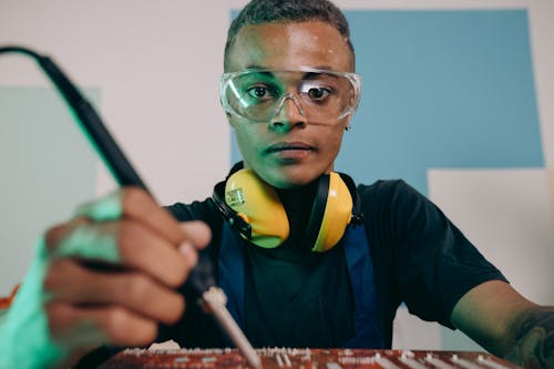 A Man Holding a Soldering Iron