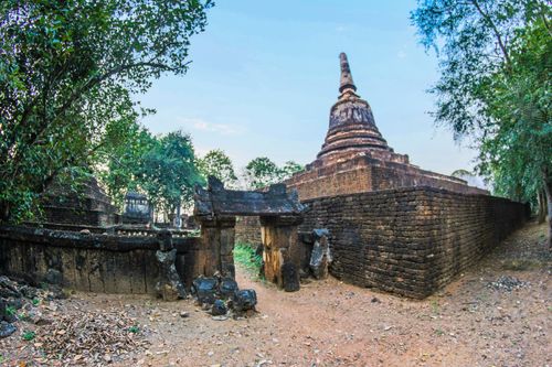Free Explore ancient Buddhist temple ruins in Thailand's lush landscape. Stock Photo