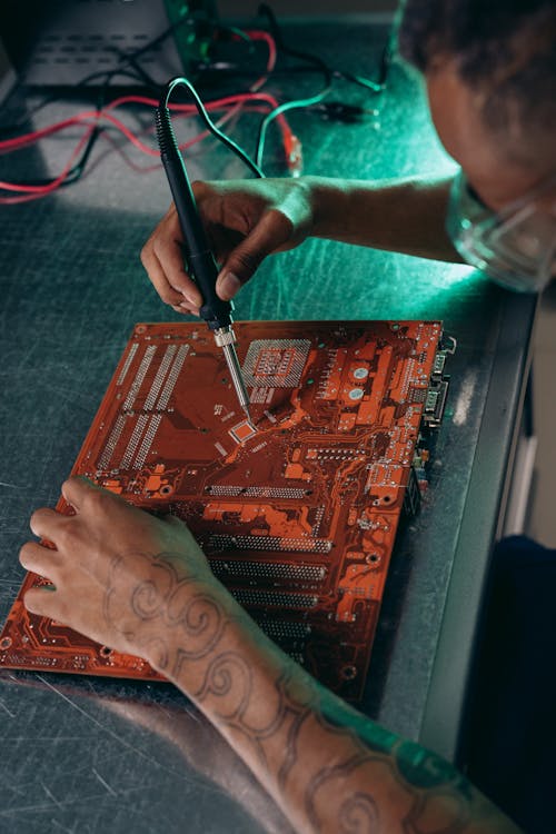 A Person Holding a Soldering Iron