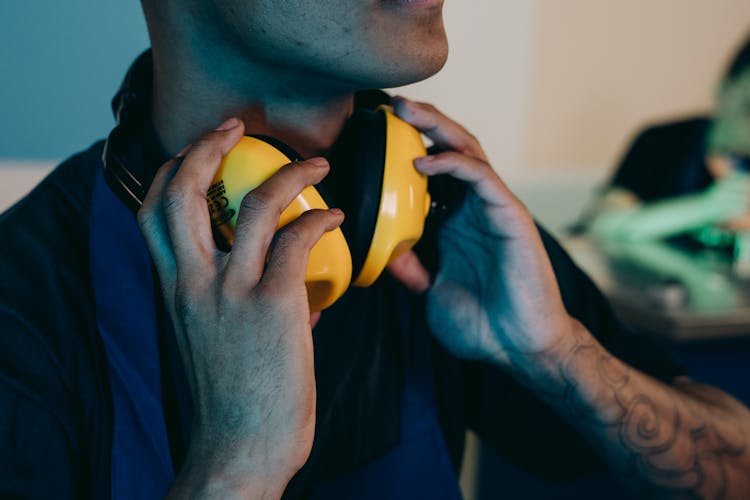 A Person Holding A Headphone