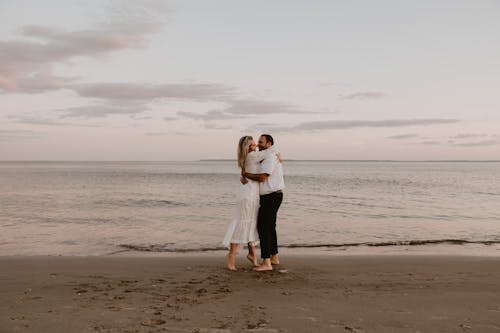 A Couple Hugging on a Beach