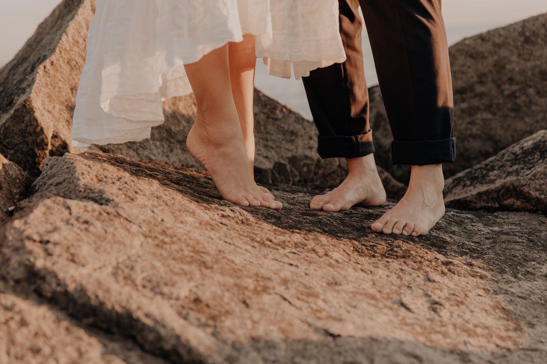 Photograph of People's Feet on a Rock · Free Stock Photo