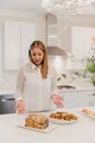 Woman in White Long Sleeve Shirt Holding Tray With Pizza