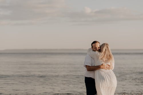 Man and Woman Embracing by Sea