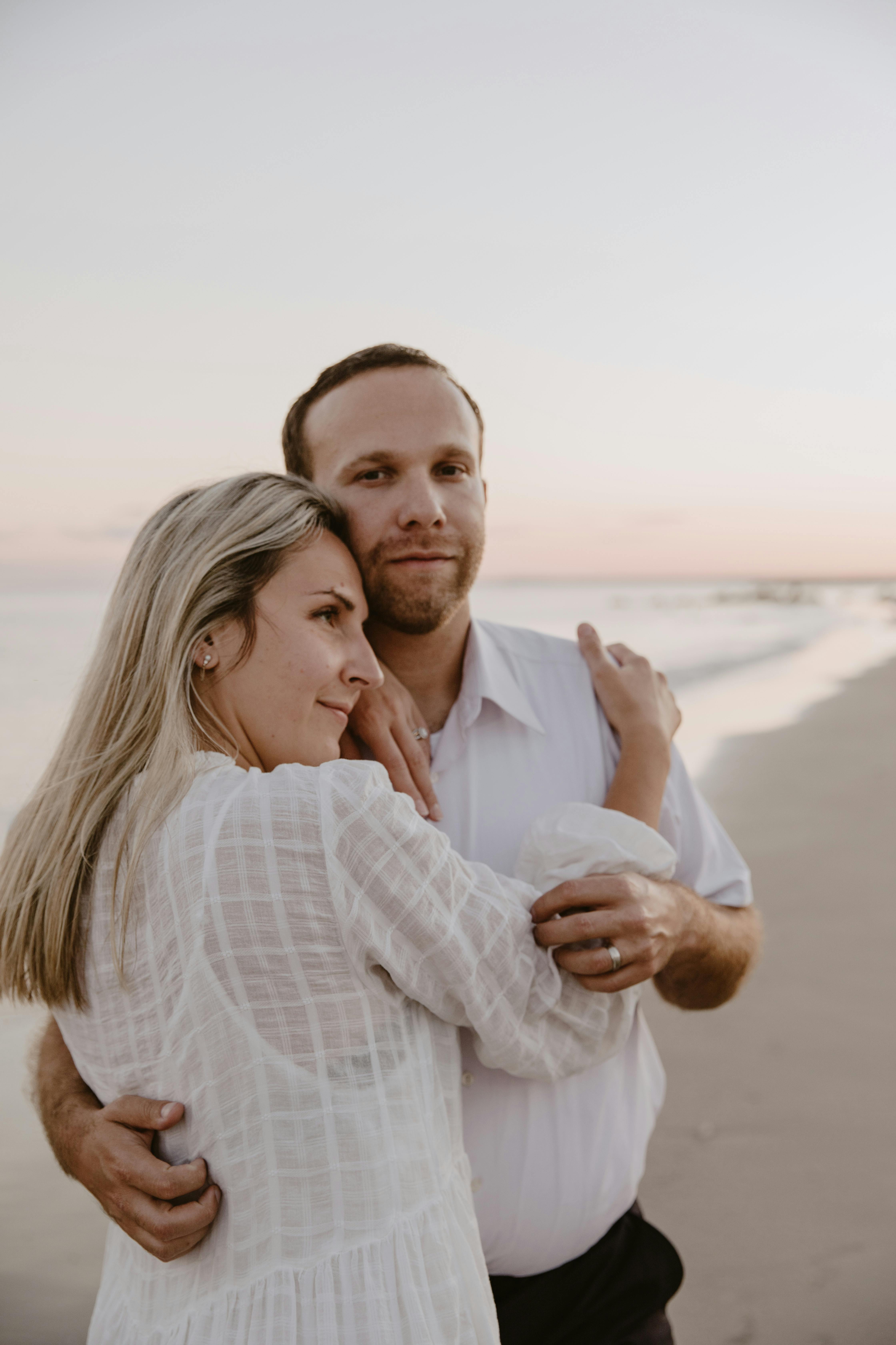 A Couple Hugging at Beach Shore · Free Stock Photo