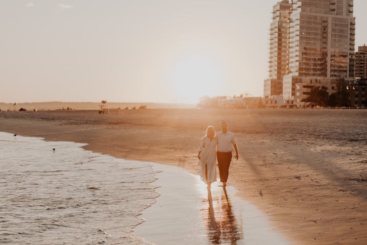 Couple Walking Together On Beach