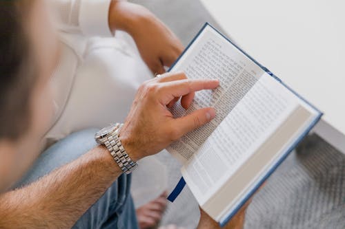 Free A Person Holding a Book Stock Photo