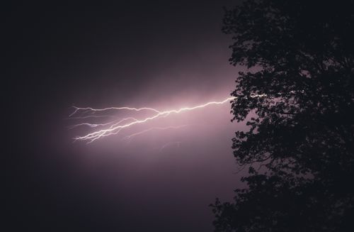 Free Captivating photo of a lightning bolt illuminating the night sky during a stormy night. Stock Photo
