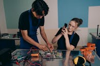 A Woman Taking Photo of a Man using a Smartphone