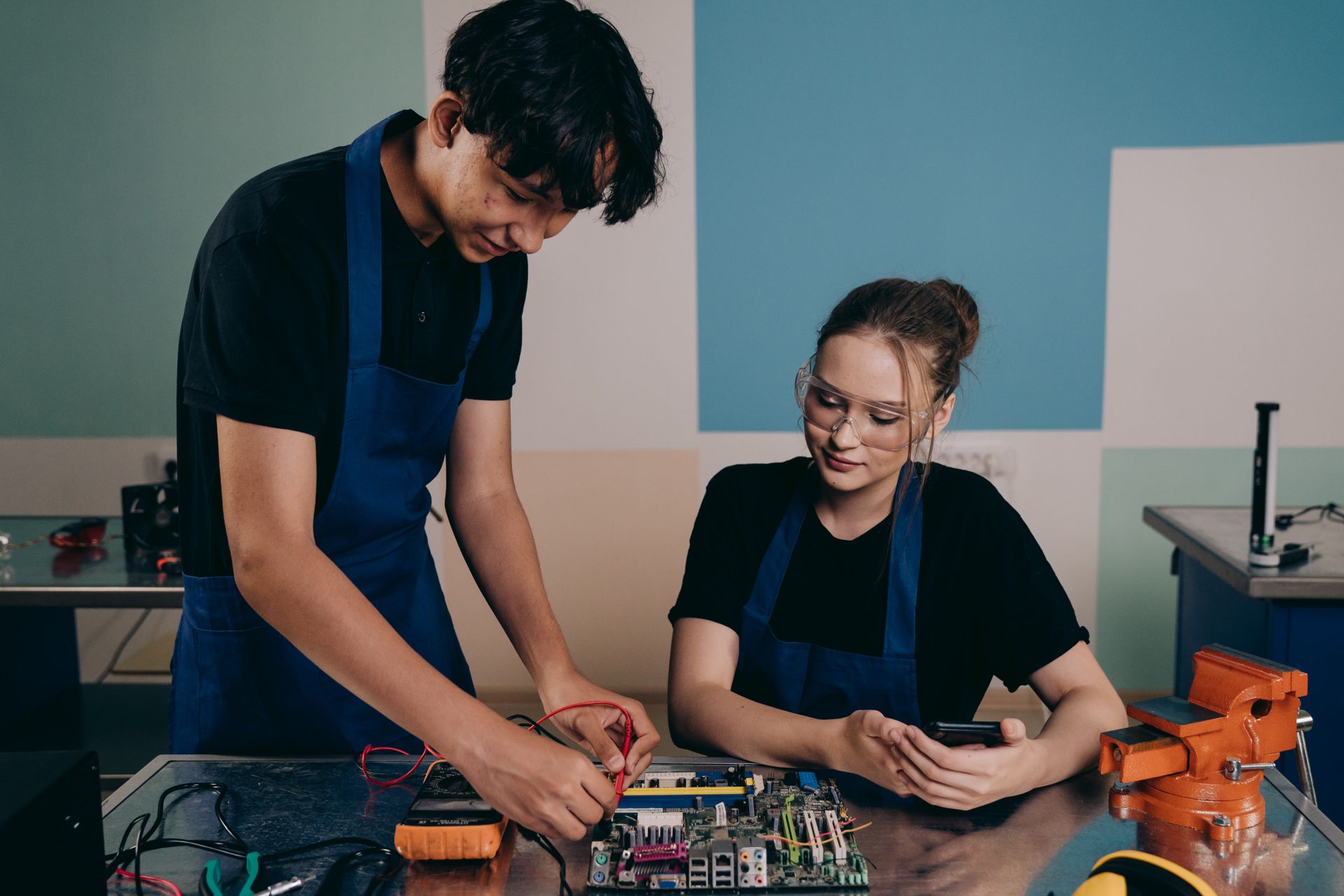 Man and Woman Testing a Motherboard