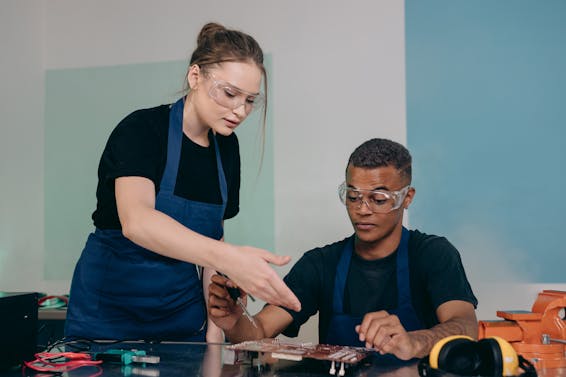 Man and Woman Checking a Motherboard