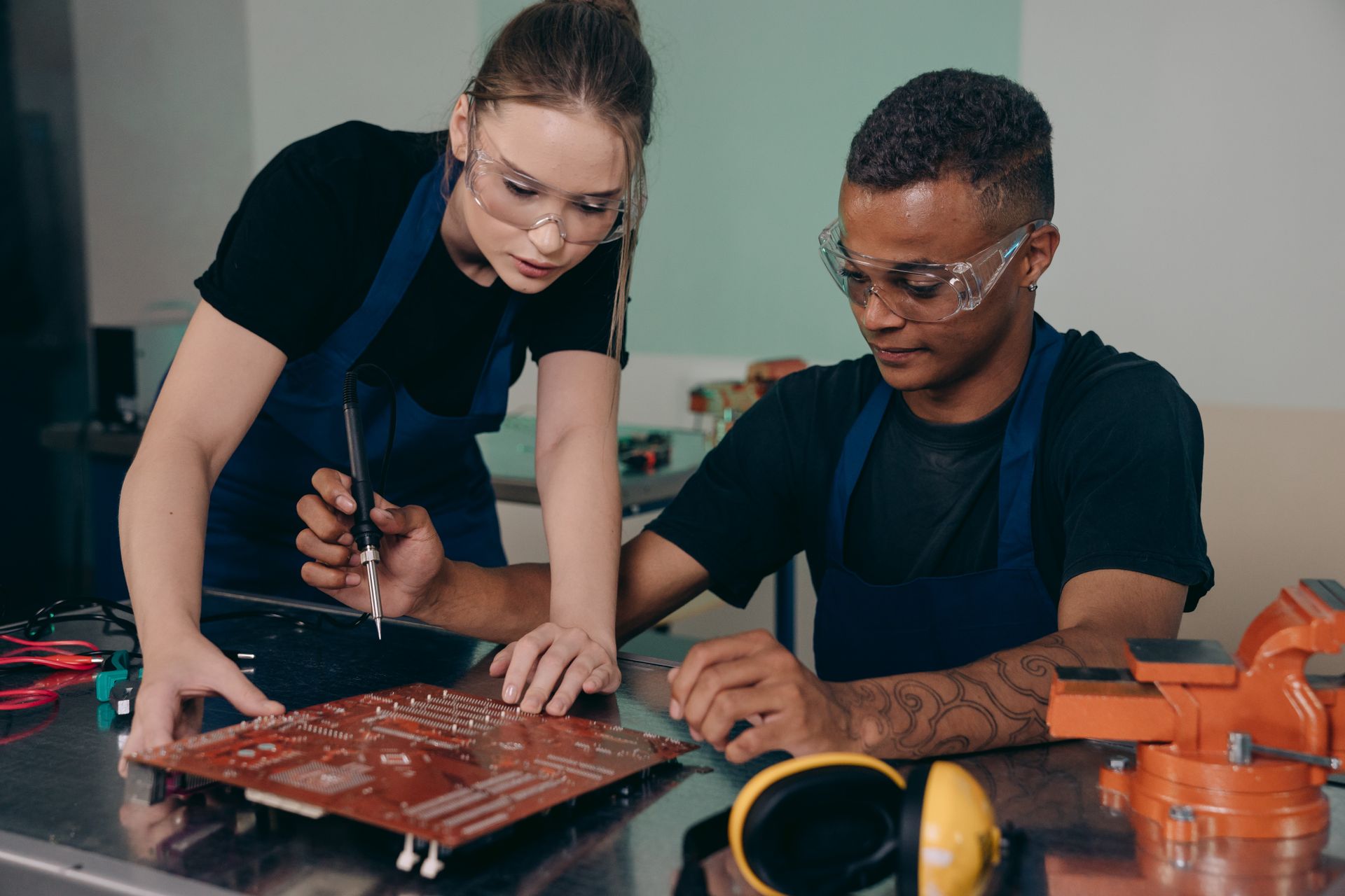 Man and Woman Checking a Motherboard