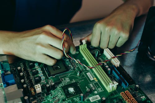 Close-up Photo of Person working on a Motherboard