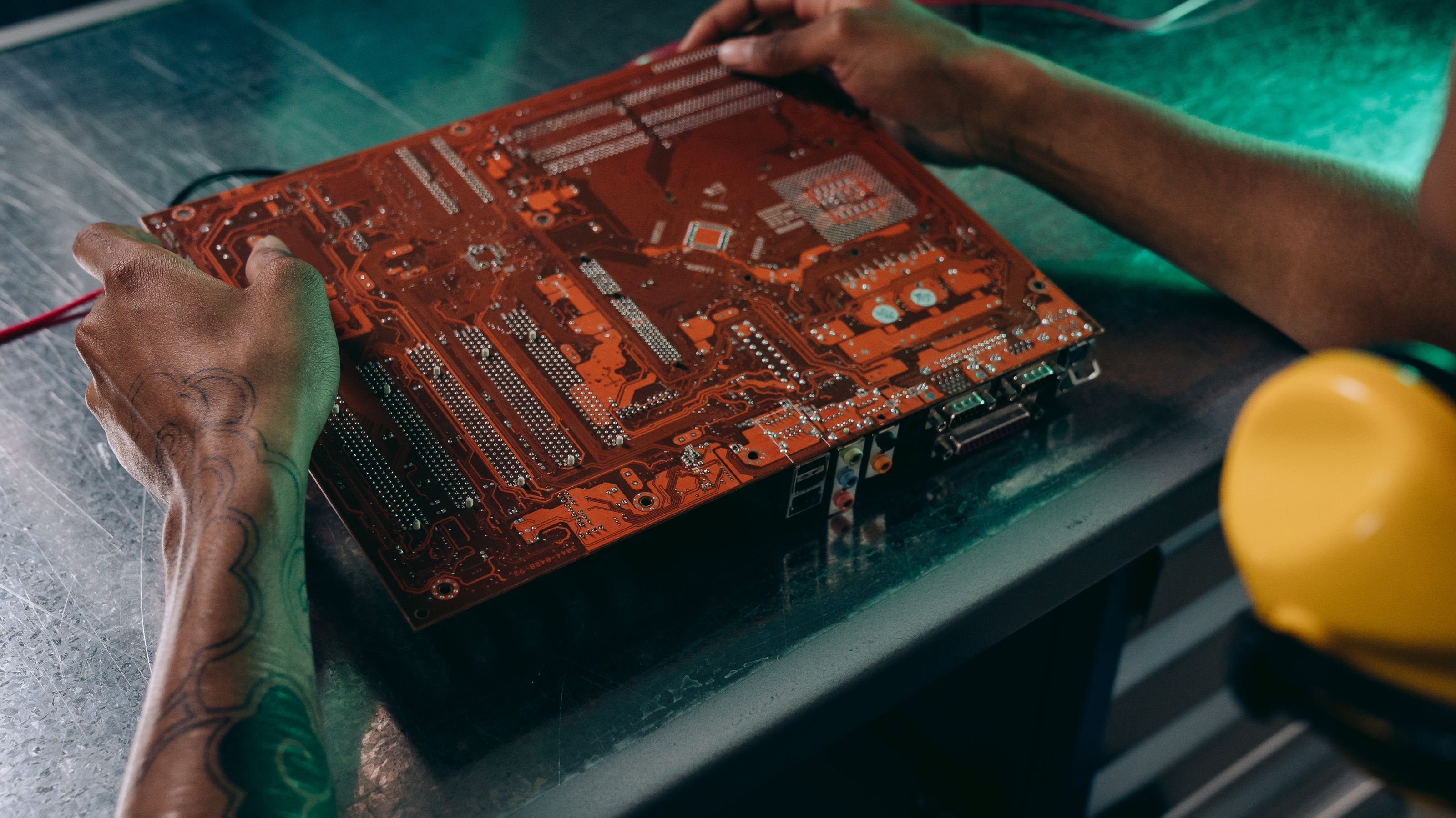 Technician examining electronic components on a circuit board