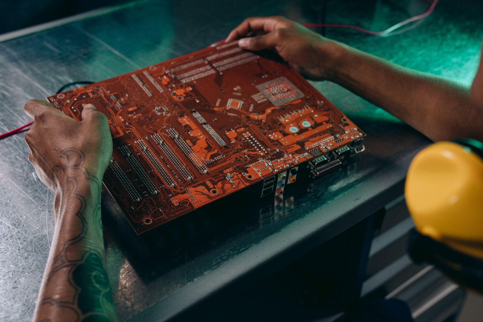 Technician working on a circuit board in an industrial setting