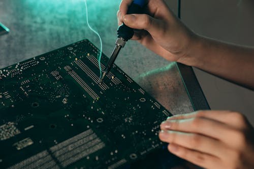 A Person Holding a Soldering Iron