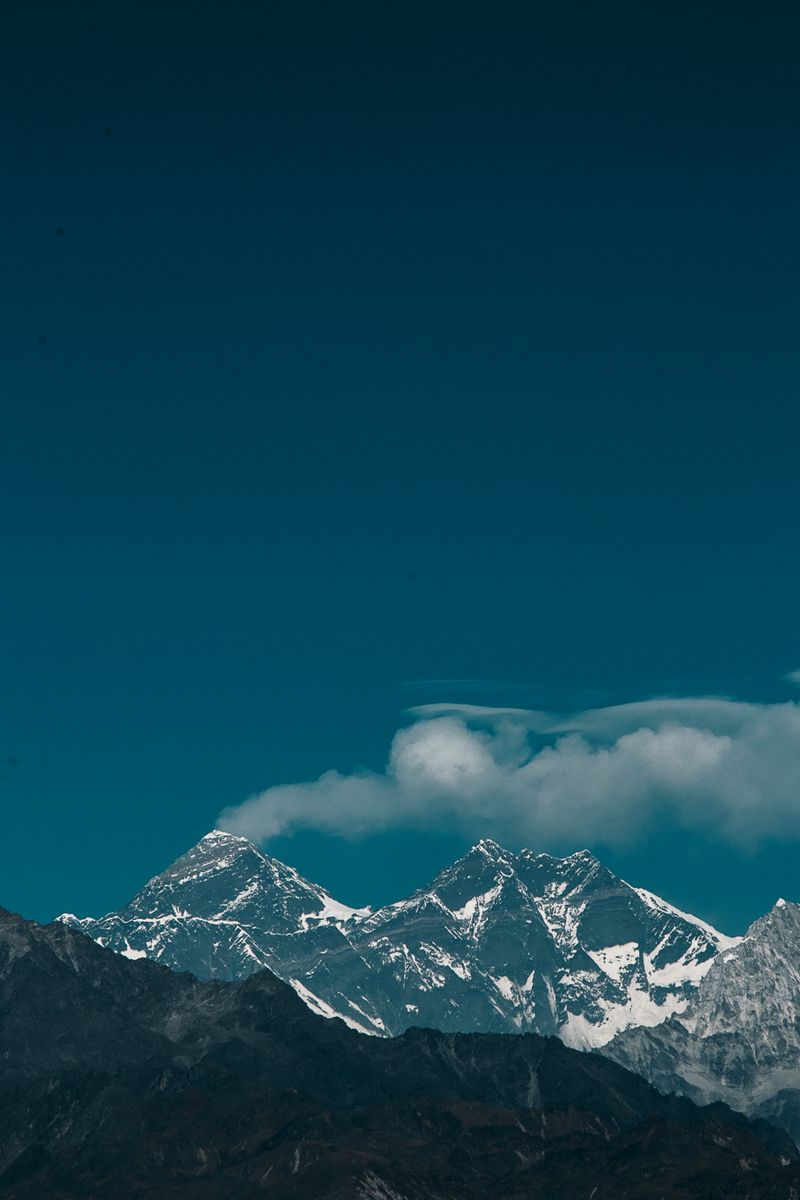 Snow-covered peaks of Mount Everest under a clear blue sky in Nepal.