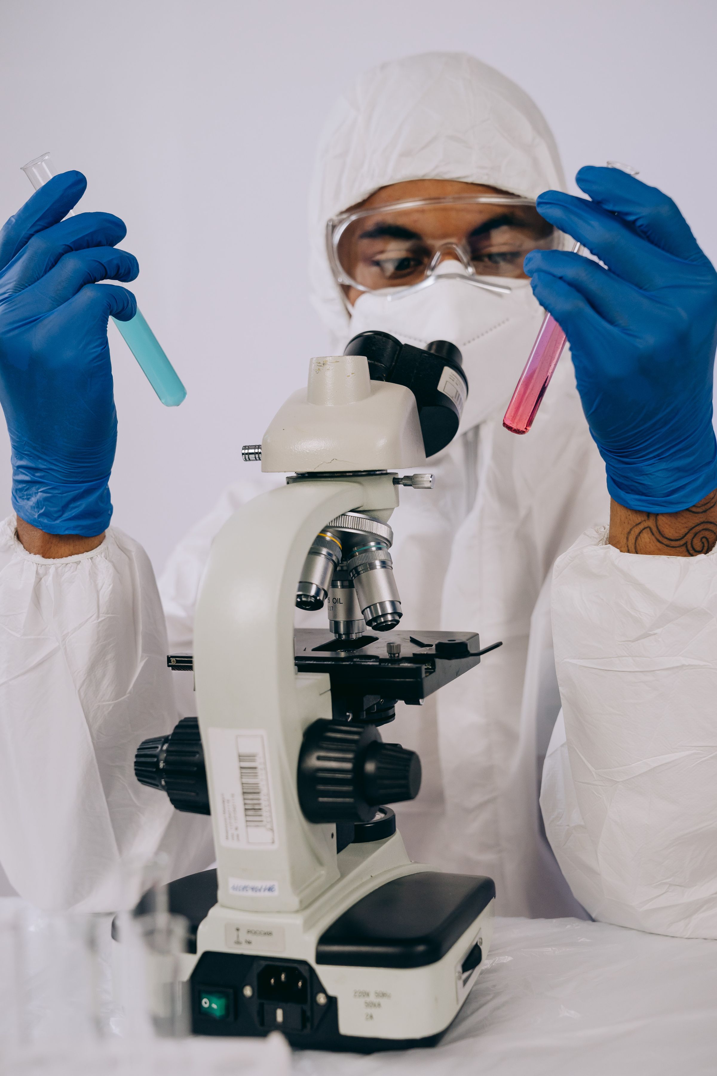 Scientist examining test tubes in a bright laboratory