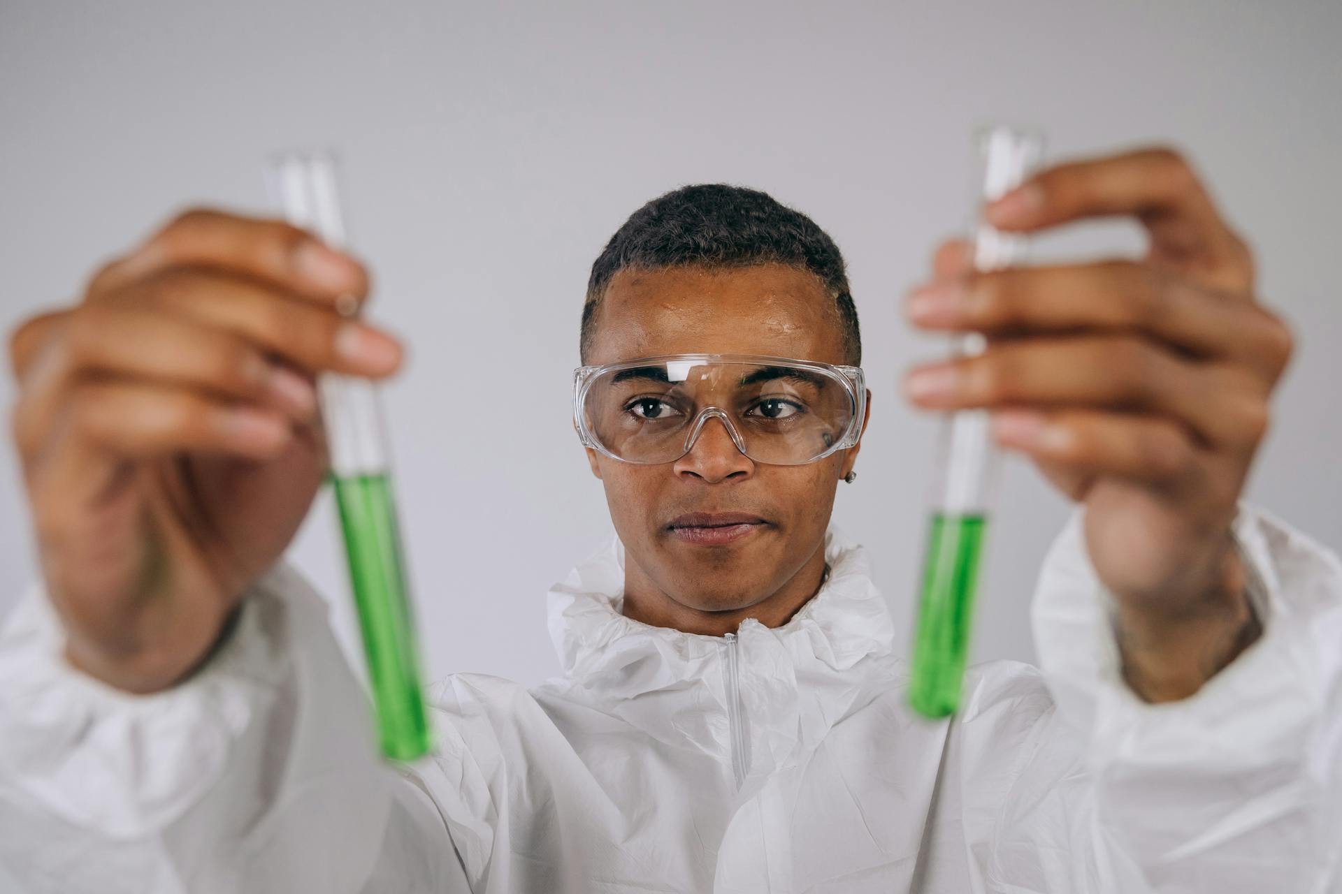 A Man Wearing Test Tubes With Green Liquid