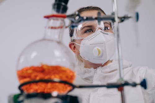 Chemist in PPE doing an Experiment