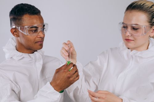 Free Two scientists in protective gear working together in a lab setting. Stock Photo